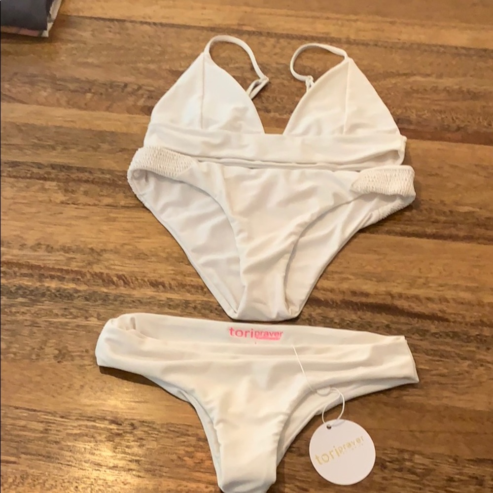Tori Praver white swim suit with one top 2 bottoms